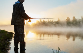 This is a picture of a guest fishing at the trout lake at Beaver Creek Resort in Gaylord, MI